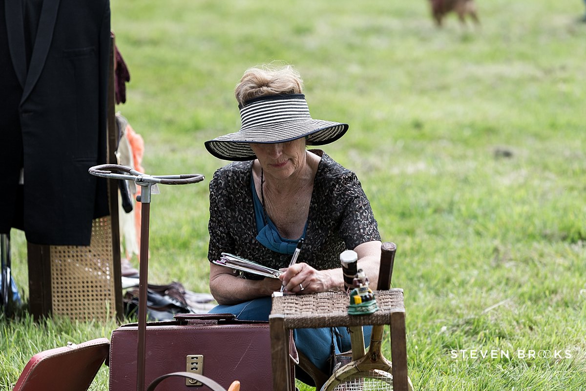 Britain Does Vintage Stody Lodge Norfolk photographer steven brooks photographs a stall holder at Britain Does Vintage at Stody Lodge