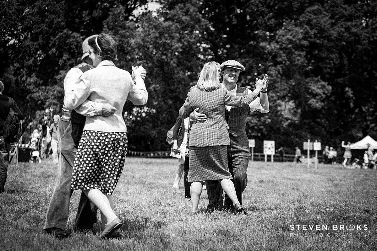 Britain Does Vintage Stody Lodge Norfolk photographer steven brooks photographs a couple dancing in vintage clothes at Britain Does Vintage at Stody Lodge in black and white