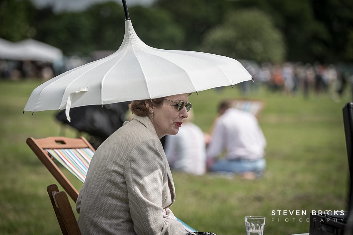 Britain Does Vintage Stody Lodge Norfolk photographer steven brooks photographs cwoman undr umbrella vintage clothes at Britain Does Vintage in Noirfolk
