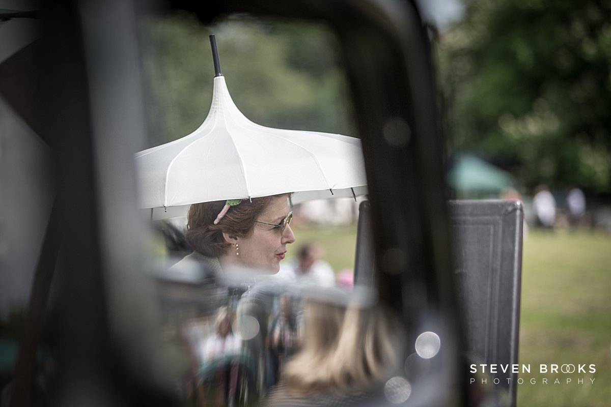 Britain Does Vintage Stody Lodge Norfolk photographer steven brooks photographs a lady in vintage clothes listening to music at Britain Does Vintage in Noirfolk
