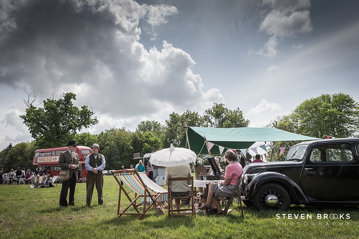 Britain Does Vintage Stody Lodge Norfolk photographer steven brooks photographs visitors vintage clothes listening to music at Britain Does Vintage in Noirfolk