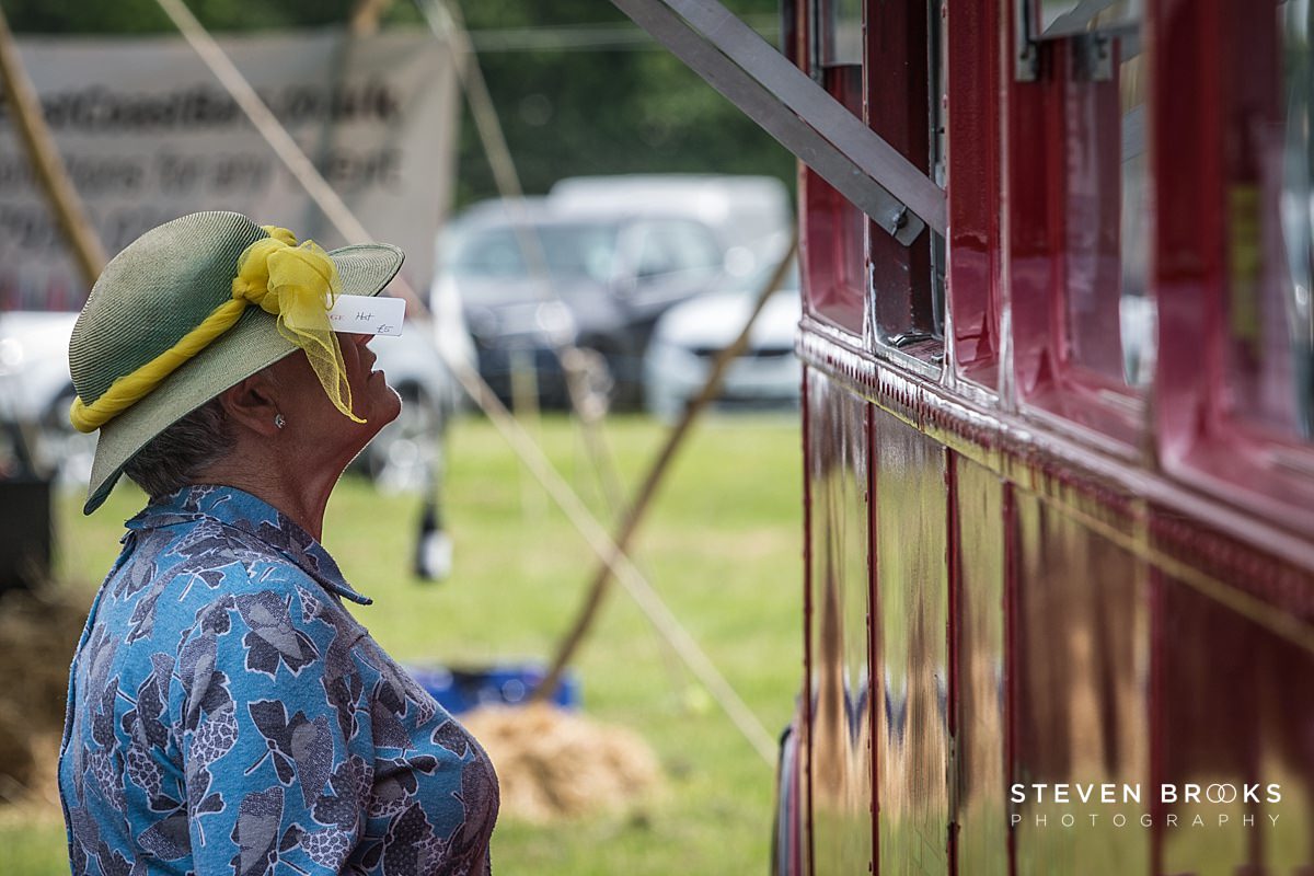 Britain Does Vintage Stody Lodge Norfolk photographer steven brooks photographs a stall holder in vintage vintage clothes at Britain Does Vintage in Norfolk