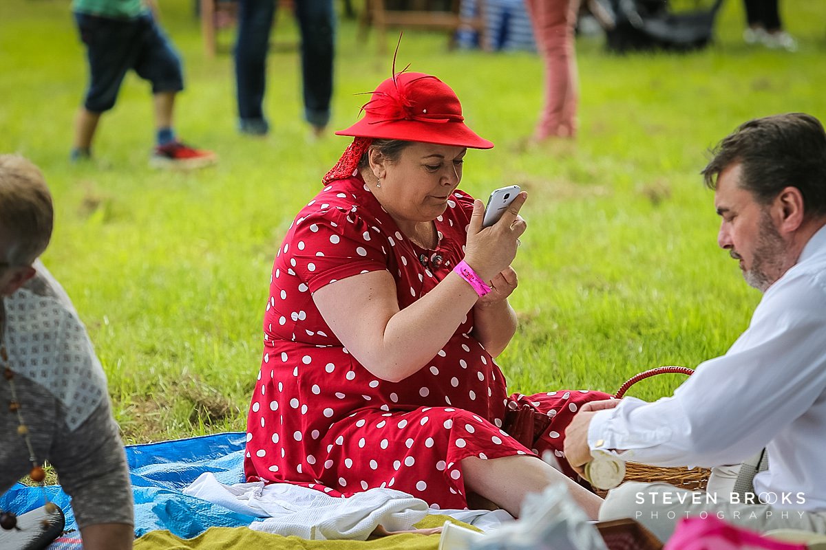 Britain Does Vintage Stody Lodge Norfolk photographer steven brooks photographs a lady in red at Britain Does Vintage in Norfolk