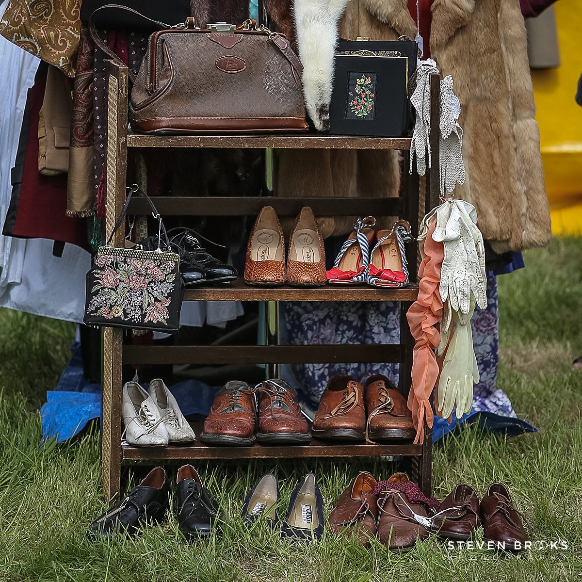 Britain Does Vintage Stody Lodge Norfolk photographer steven brooks photographs a rack of vintage shoes at Britain Does Vintage in Norfolk