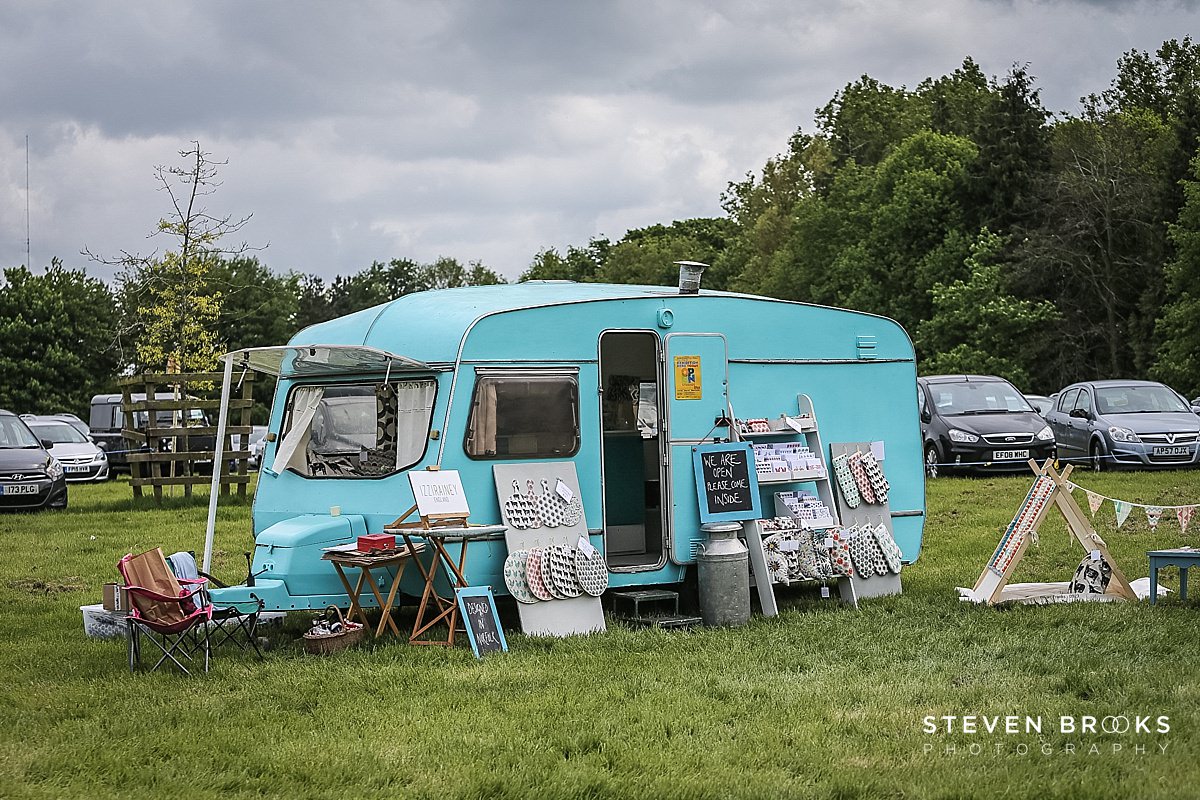 Britain Does Vintage Stody Lodge Norfolk photographer steven brooks photographs a blue caravan at Britain Does Vintage in Norfolk