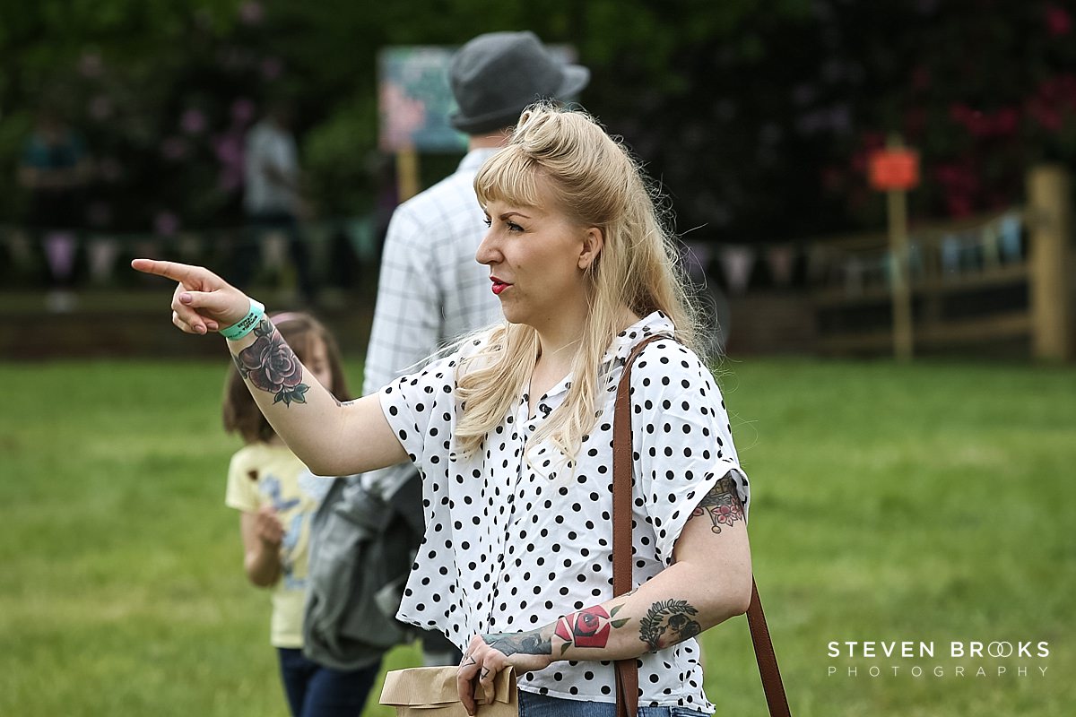 Britain Does Vintage Stody Lodge Norfolk photographer steven brooks photographs a tattooed woman with vintage hairstyle at Britain Does Vintage in Norfolk