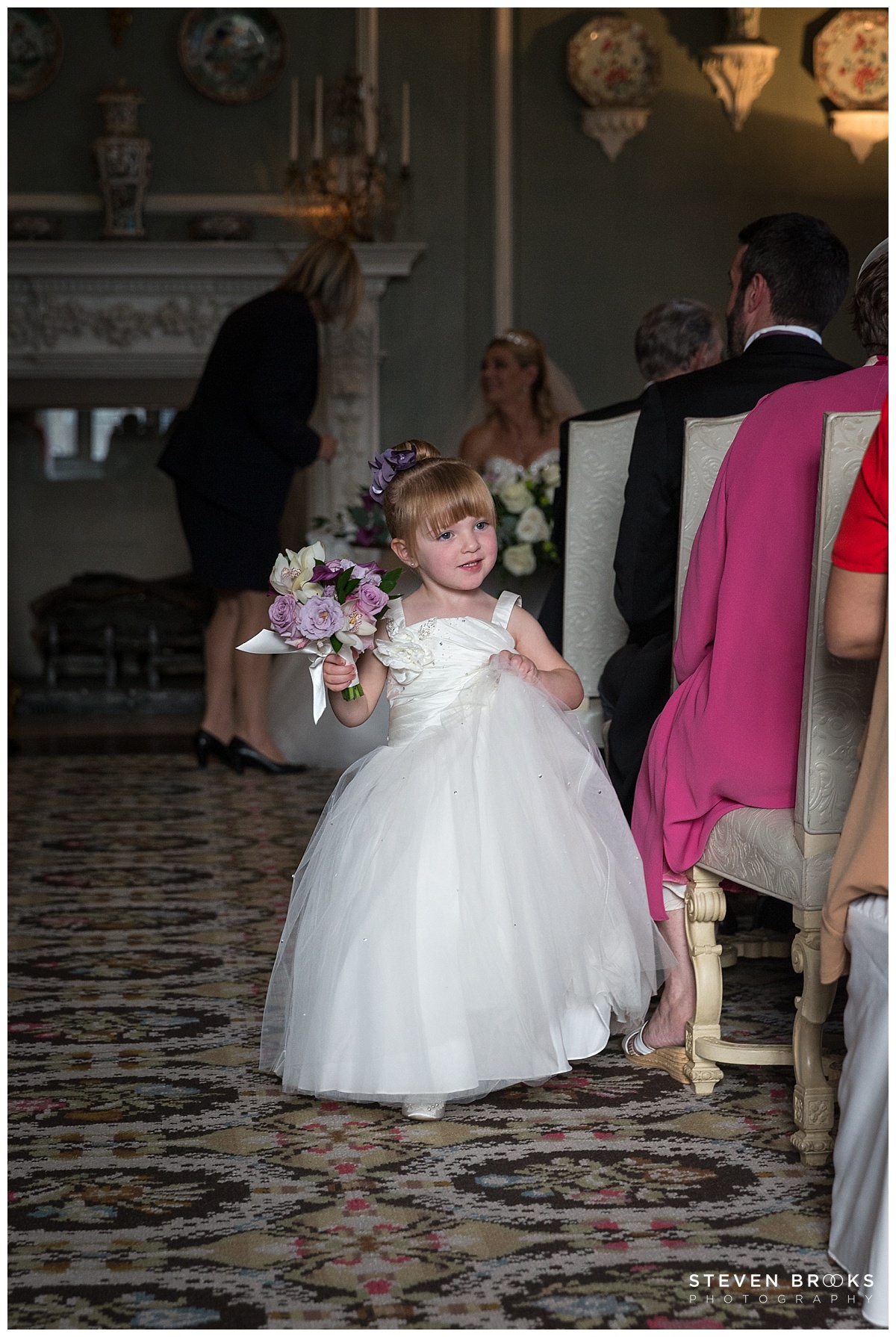 Maria & Trevor: Leeds Castle Leeds Castle wedding photographer steven brooks photographs a flower girl in the wedding ceremony room at Leeds Castle